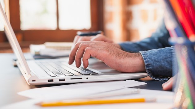 Business people working on laptop at home, quarantine from coronavirus covid-19, work from home or work at home and social distancing concept
