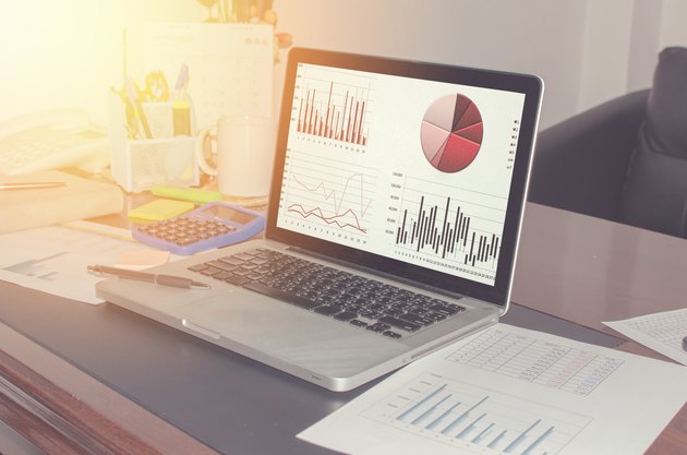 Close-Up Of Graphs In Laptop On Table