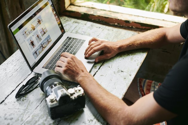 Male on laptop in beach hut