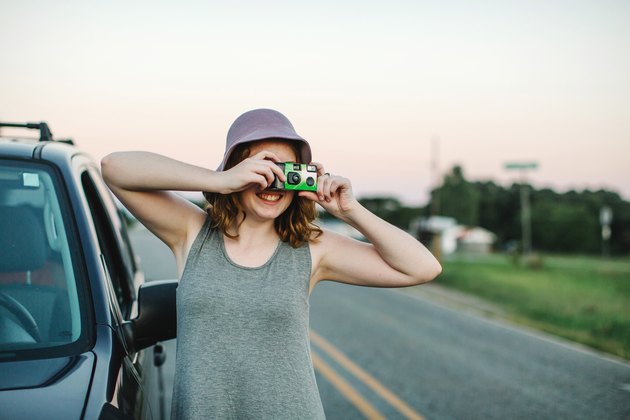 Woman using disposable camera to take photograph