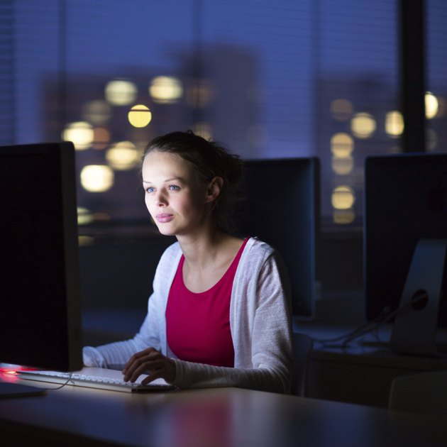 Pretty, young female college student using a desktop computer/pc