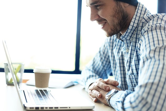 Handsome man working from his home office. Analyze business plans