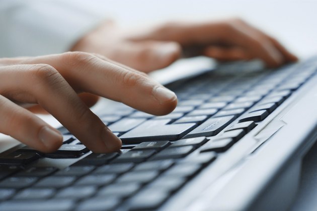 Image of man's hands typing. Selective focus