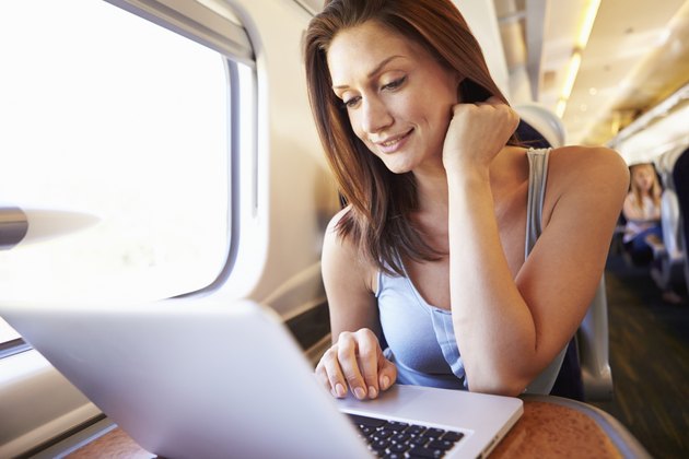 Woman Using Laptop On Train