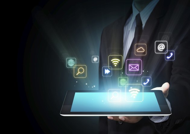 Tablet with cloud of colorful application icons