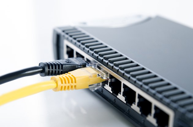 Network switch device and ethernet cables on white