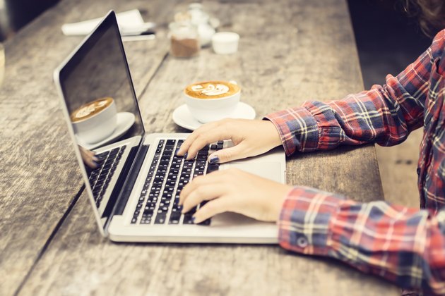 Schoolgirl with laptop and cappuccino