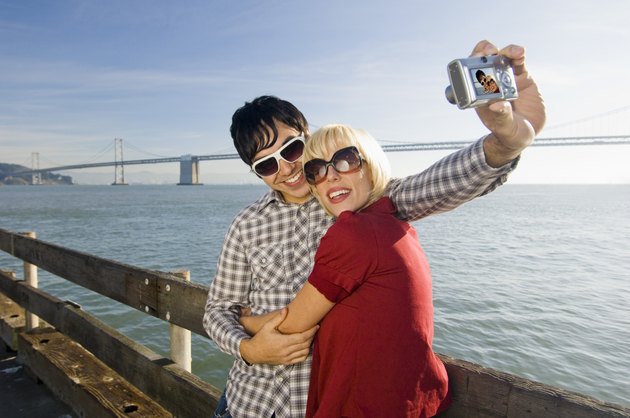 Couple taking picture by water