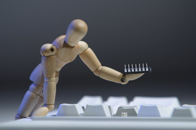 Figurine fixing broken keyboard