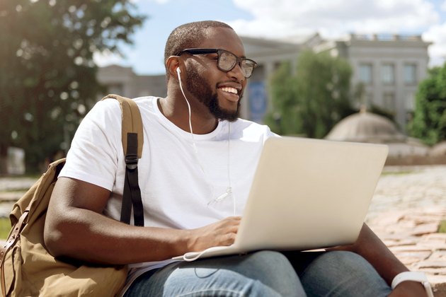 Cheerful man sitting in the street