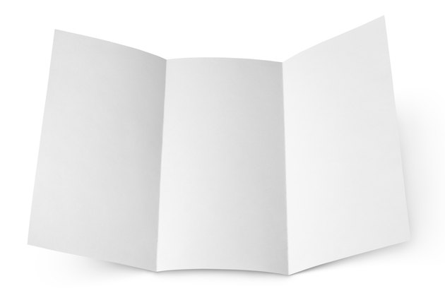 Blank folded flyer on white