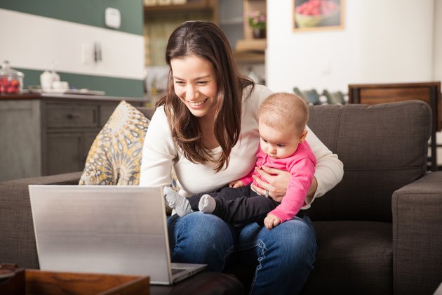 Young mom working at home with her baby