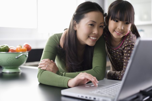 Mother and daughter using laptop computer
