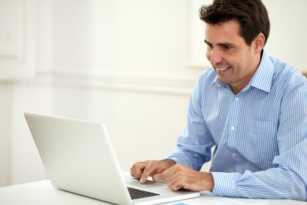 Alone adult businessman working on his laptop