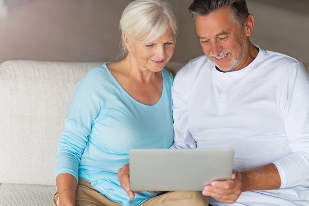 Senior couple using laptop