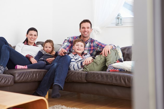Family Relaxing Indoors Watching Television Together