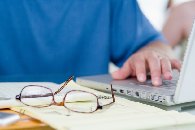 Man with laptop computer and eyeglasses