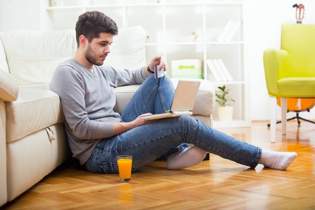 Casual paying online with credit card at home