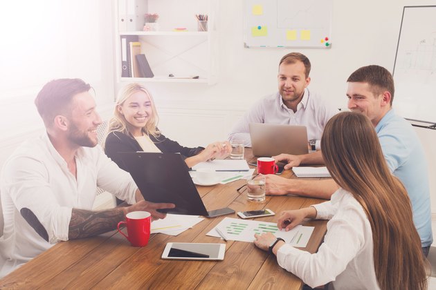 Business meeting. Young hipsters businessmen and women at modern