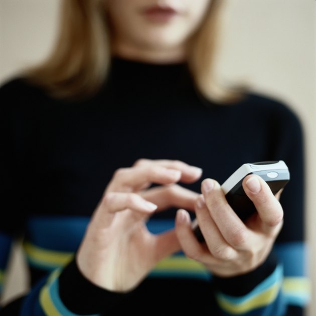 Young Woman Dialing Mobile Phone