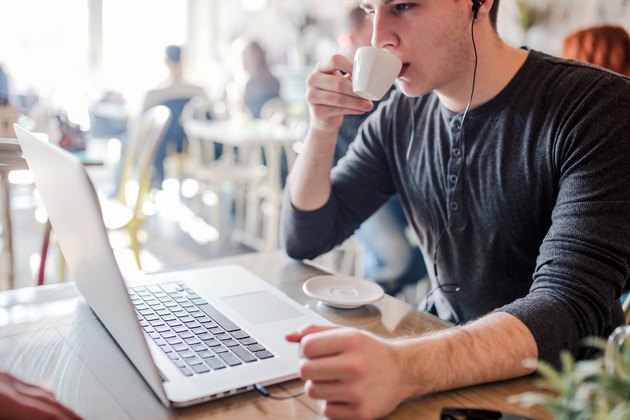 Young hipster man drinking his coffee in a cafe bar