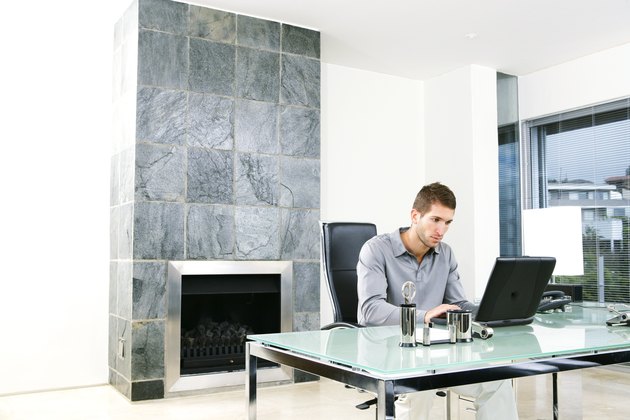 Man using laptop in home office