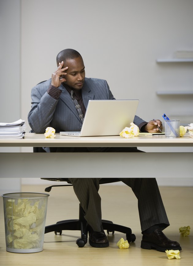 African American businessman looking at laptop