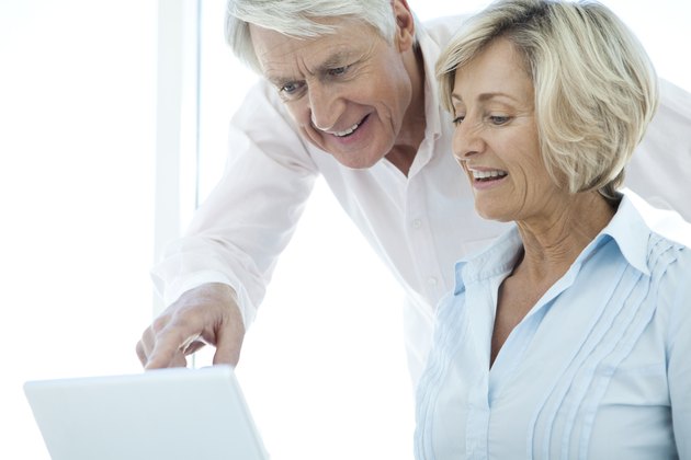 Happy Senior Couple communicating online.