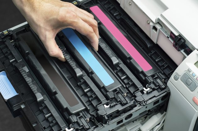 Man puts toner in the printer