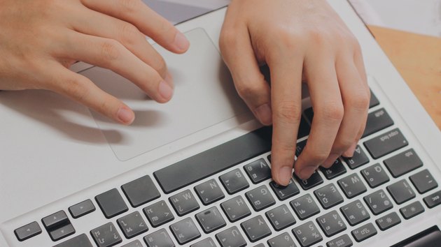 Hand using laptop