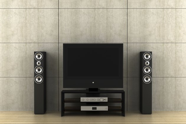 modern tv with speakers in front of gray wall