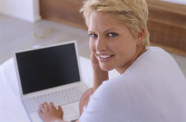 Portrait of a young woman working on a laptop