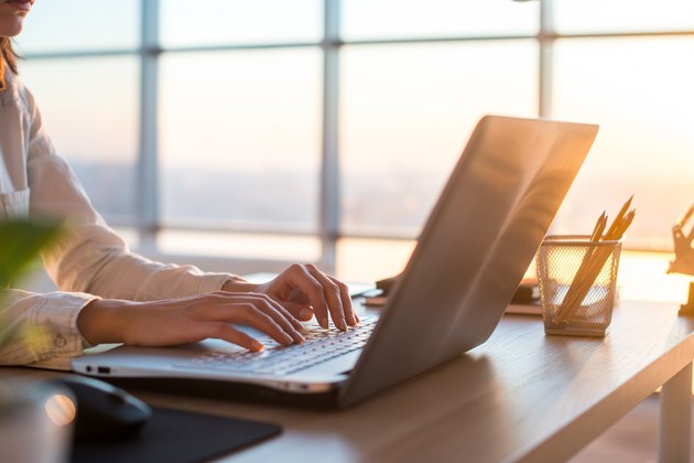 Adult businesswoman working at home using computer, studying business ideas