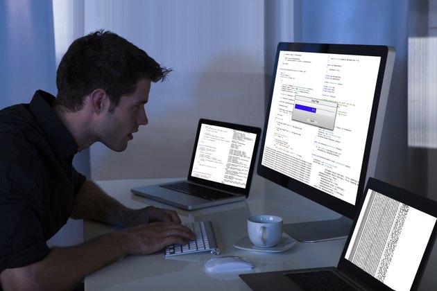 Man Working With Computer And Laptop