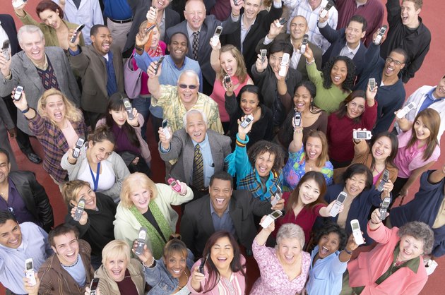 Elevated View of a Large Crowd of Smiling People Holding Mobile Phones in the Air