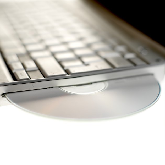 CD-DVD poking out of side of keyboard, close up