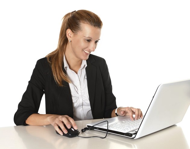Young Attractive Business Woman working in Computer