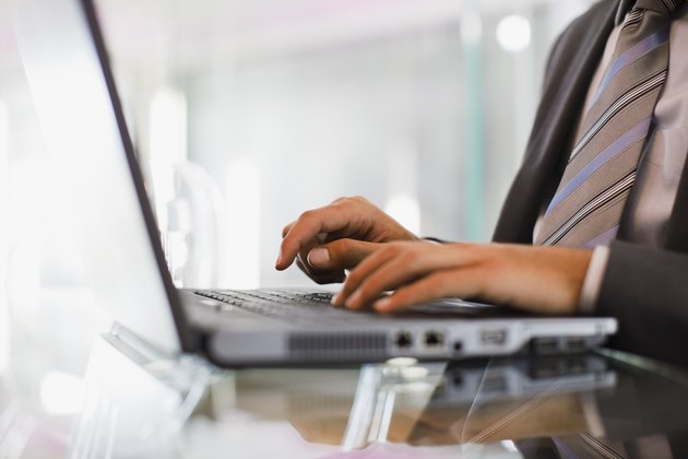 Businessman typing on laptop