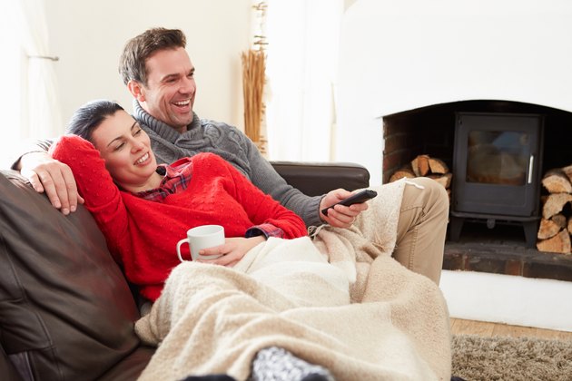 Couple Relaxing At Home Watching Television