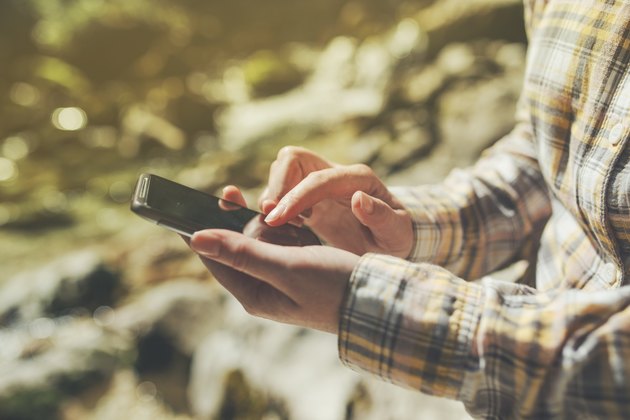 Female tourist using mobile smart phone for GPS navigation