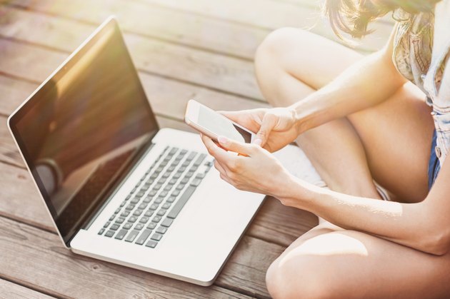 Girl using a laptop and smart phone