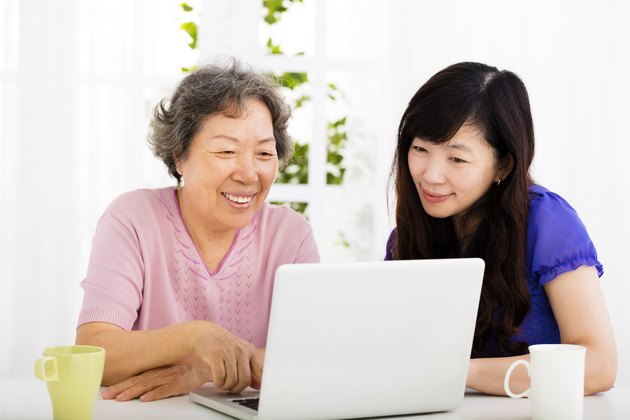 happy senior Mother and daughter learning laptop