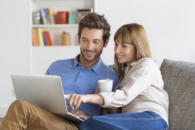 Young couple surfing on internet with laptop.