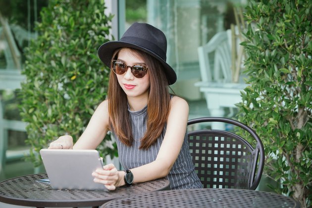 woman using smartphone in coffee shop ,asian
