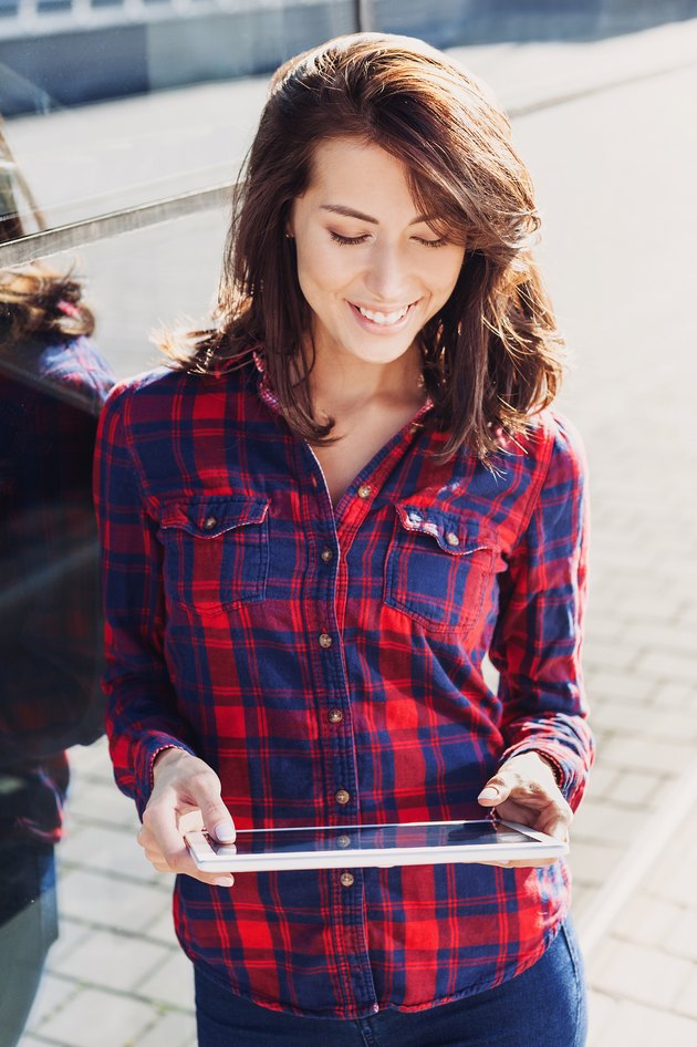 Girl using digital tablet outdoors