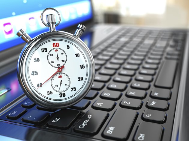 Stopwatch on laptop keyboard.