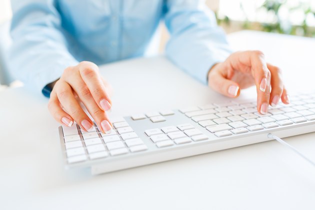 Woman office worker typing on the keyboard