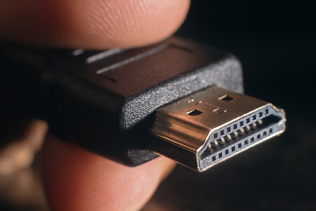 Hand holding black HDMI cable. Closeup HDMI cable.