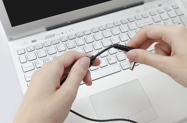 Broken charger cable in human hands
