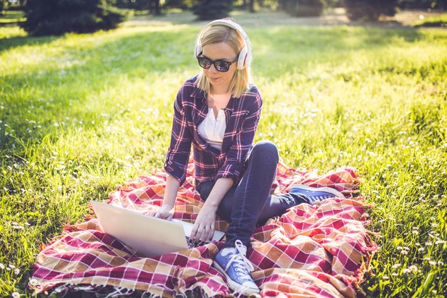 Girl on the grass using laptop